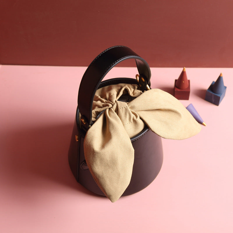 Leather bow bucket bag